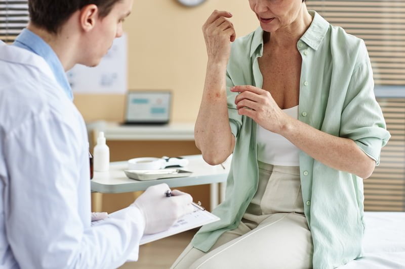Close up of mature woman explaining symptoms of skin condition